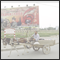 Man with donkey cart. Propaganda poster tells - Progress in time. Evolution with new ideas. Military and population do support each other. Kucha, Xinjiang, CHN