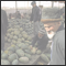 Uygur men at a stall full of melones. Kashgar, Xinjiang, CHN