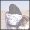 08. Hooded Bedouin woman with her children in the dessert, ARE